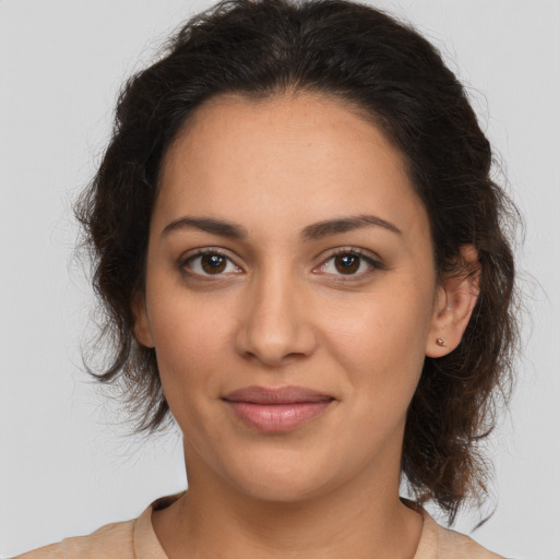 Joyful latino young-adult female with medium  brown hair and brown eyes