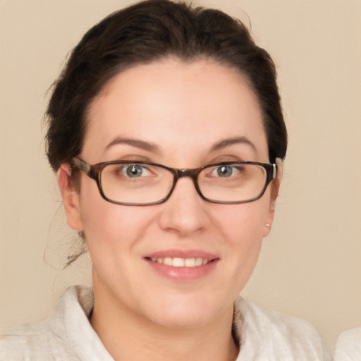 Joyful white young-adult female with short  brown hair and green eyes