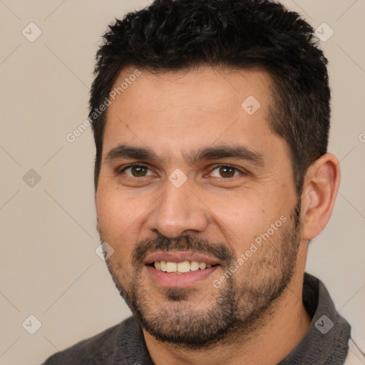 Joyful white young-adult male with short  black hair and brown eyes