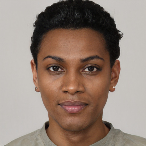 Joyful black young-adult female with short  black hair and brown eyes