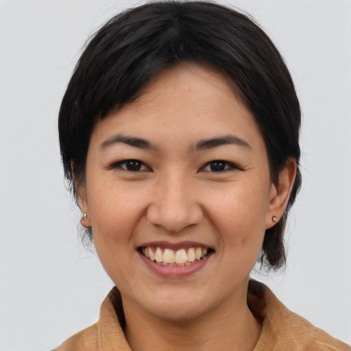Joyful asian young-adult female with medium  brown hair and brown eyes