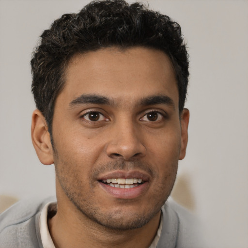 Joyful white young-adult male with short  black hair and brown eyes