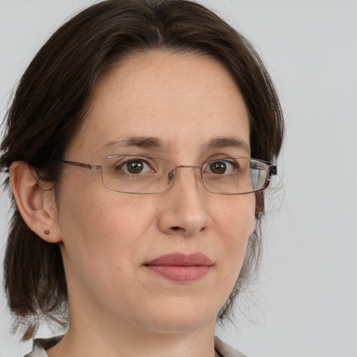 Joyful white adult female with medium  brown hair and brown eyes