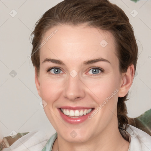 Joyful white young-adult female with medium  brown hair and blue eyes