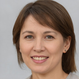 Joyful white adult female with medium  brown hair and brown eyes