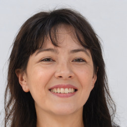 Joyful white adult female with long  brown hair and brown eyes