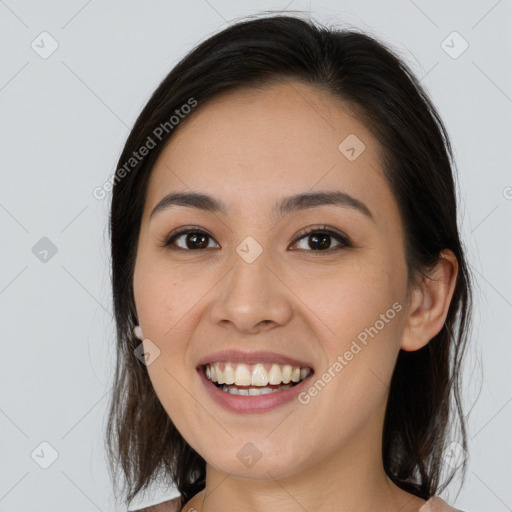 Joyful white young-adult female with long  brown hair and brown eyes