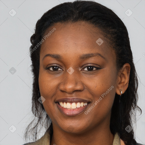 Joyful black young-adult female with long  brown hair and brown eyes