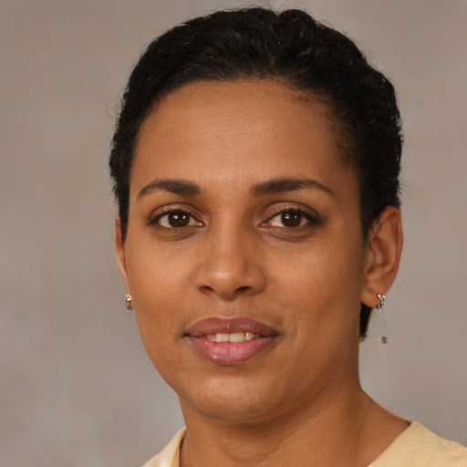 Joyful latino young-adult female with short  black hair and brown eyes
