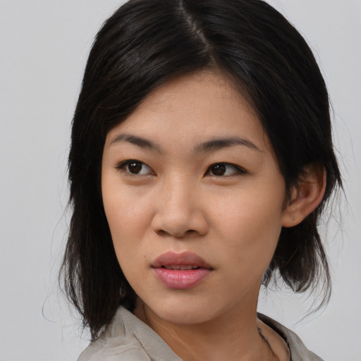 Joyful asian young-adult female with medium  black hair and brown eyes