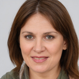 Joyful white adult female with long  brown hair and brown eyes