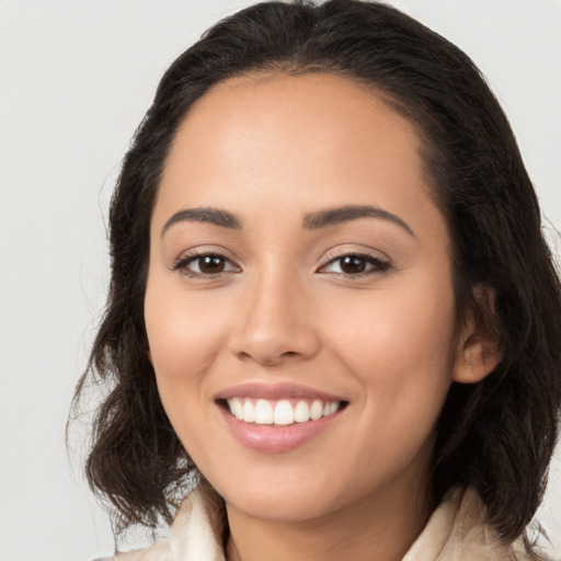 Joyful white young-adult female with long  brown hair and brown eyes