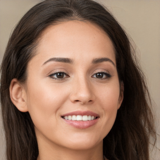 Joyful white young-adult female with long  brown hair and brown eyes