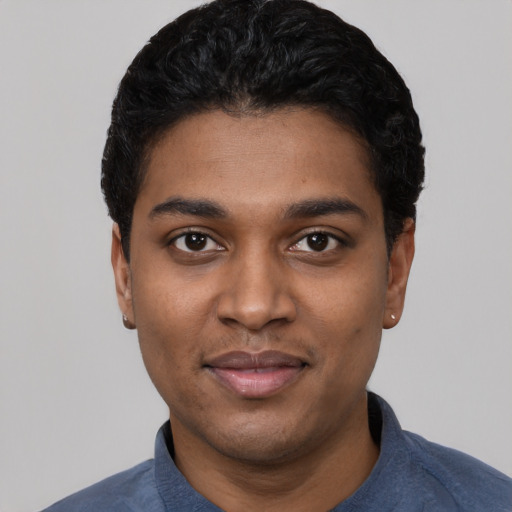 Joyful black young-adult male with short  black hair and brown eyes
