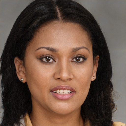 Joyful black young-adult female with long  brown hair and brown eyes