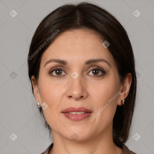 Joyful white adult female with medium  brown hair and brown eyes