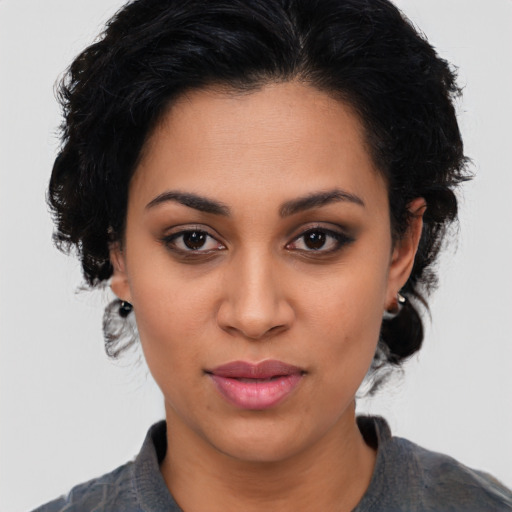 Joyful latino young-adult female with medium  black hair and brown eyes
