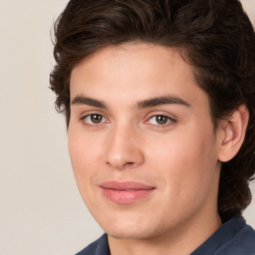 Joyful white young-adult male with medium  brown hair and brown eyes