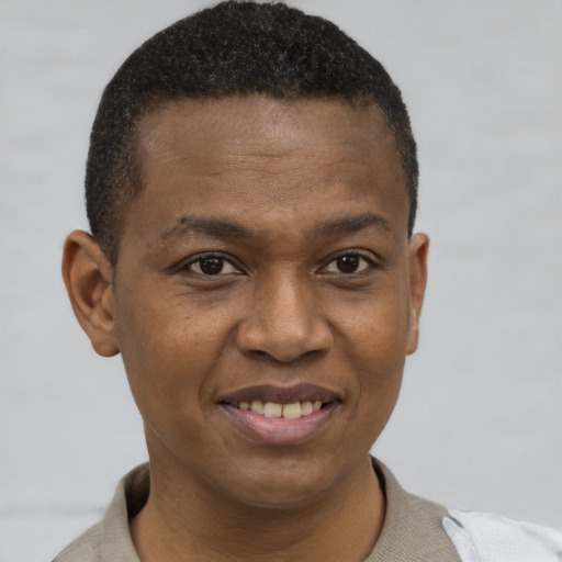 Joyful latino young-adult male with short  brown hair and brown eyes