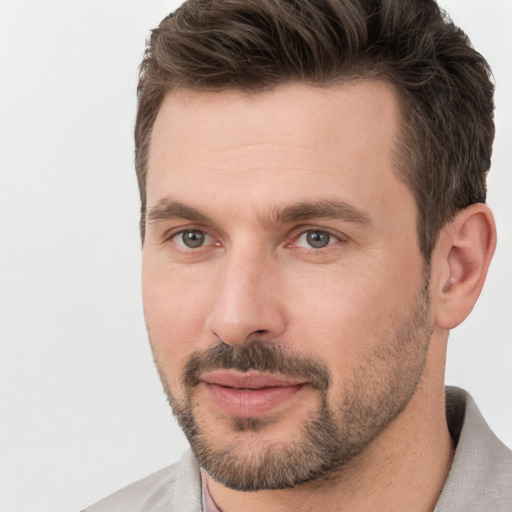 Joyful white adult male with short  brown hair and brown eyes