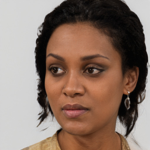 Neutral black young-adult female with medium  black hair and brown eyes