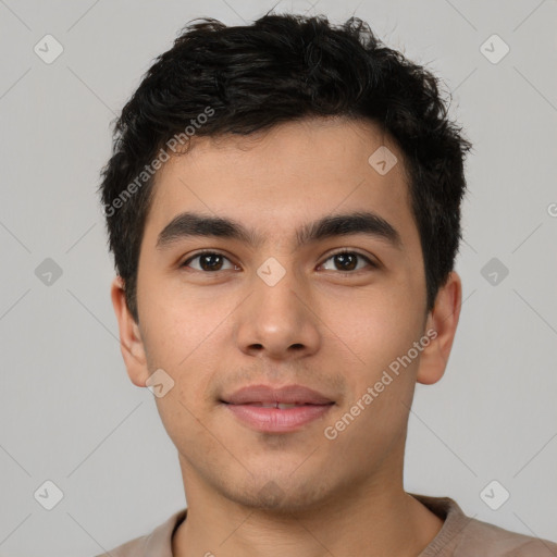 Joyful latino young-adult male with short  brown hair and brown eyes