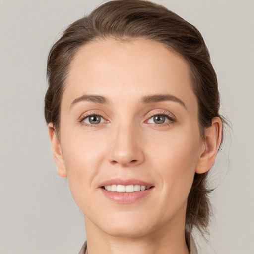 Joyful white young-adult female with medium  brown hair and grey eyes