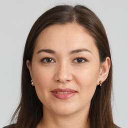 Joyful white young-adult female with long  brown hair and brown eyes