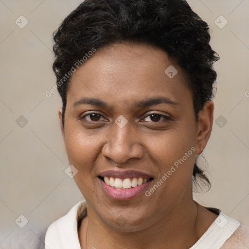 Joyful black young-adult female with short  brown hair and brown eyes