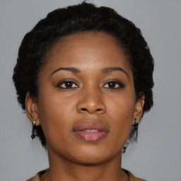 Joyful black young-adult female with medium  brown hair and brown eyes
