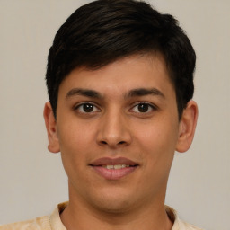 Joyful latino young-adult male with short  brown hair and brown eyes