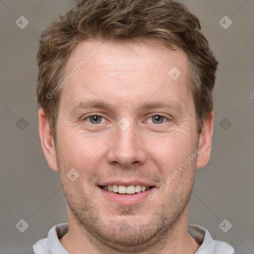 Joyful white adult male with short  brown hair and grey eyes