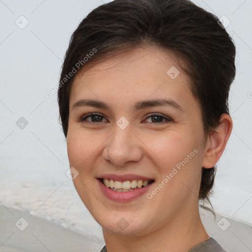 Joyful white young-adult female with short  brown hair and brown eyes