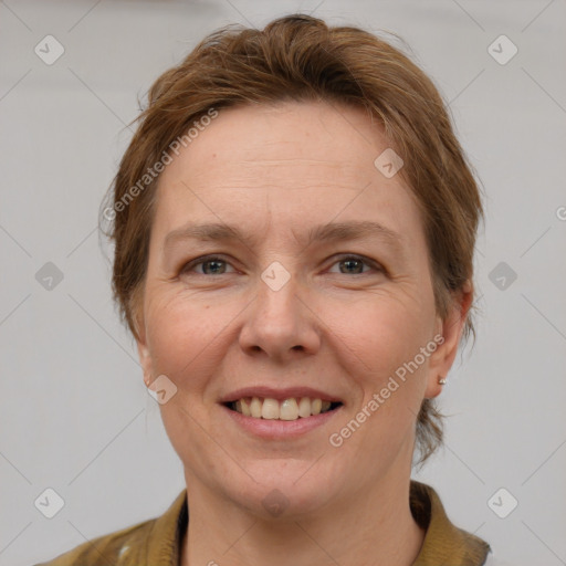 Joyful white adult female with short  brown hair and grey eyes