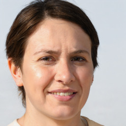 Joyful white adult female with medium  brown hair and brown eyes