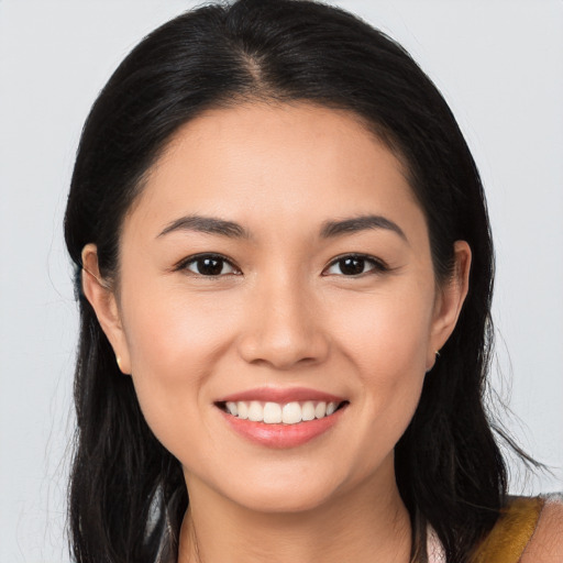 Joyful white young-adult female with long  brown hair and brown eyes