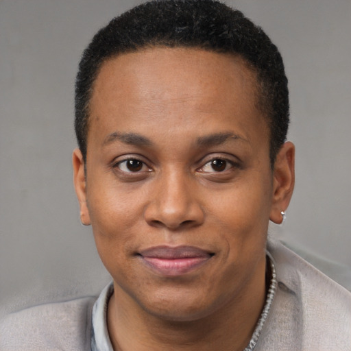 Joyful black young-adult male with short  black hair and brown eyes