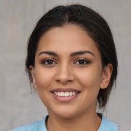 Joyful latino young-adult female with medium  brown hair and brown eyes