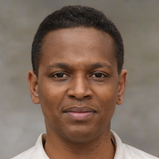 Joyful latino young-adult male with short  brown hair and brown eyes