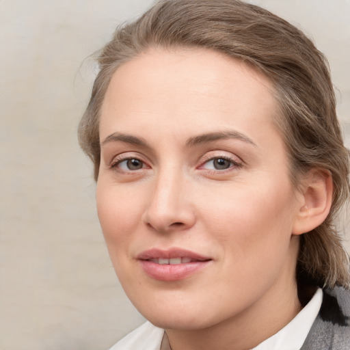 Joyful white young-adult female with medium  brown hair and blue eyes