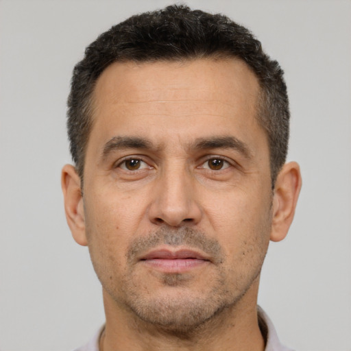 Joyful white adult male with short  brown hair and brown eyes