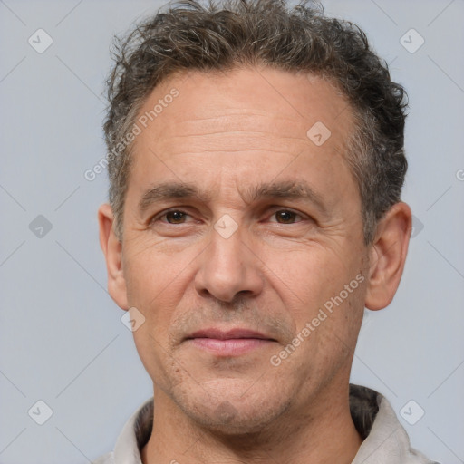 Joyful white middle-aged male with short  brown hair and brown eyes