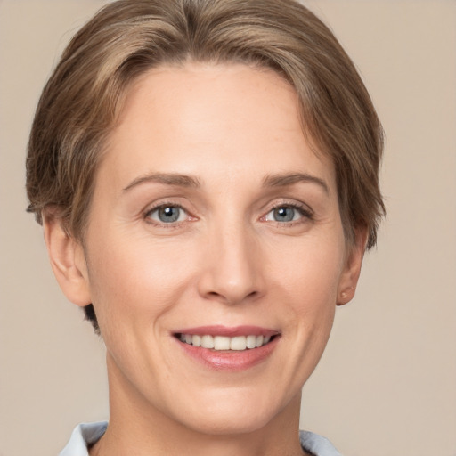 Joyful white adult female with short  brown hair and grey eyes