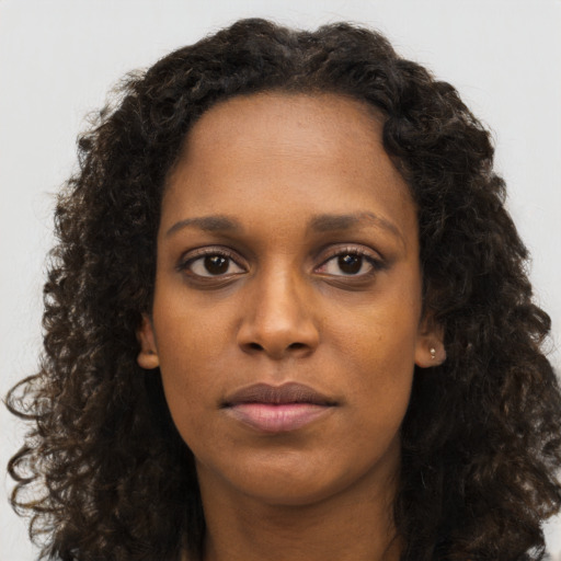 Neutral black young-adult female with long  brown hair and brown eyes