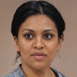 Joyful black young-adult female with medium  brown hair and brown eyes