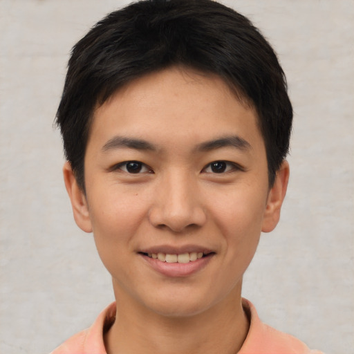 Joyful asian young-adult male with short  brown hair and brown eyes