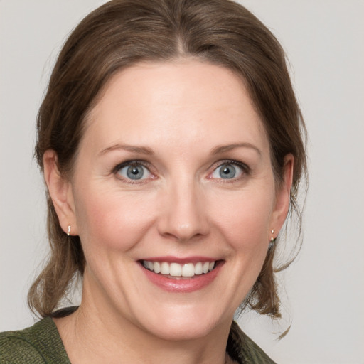 Joyful white young-adult female with medium  brown hair and blue eyes