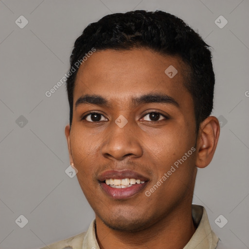 Joyful black young-adult male with short  black hair and brown eyes