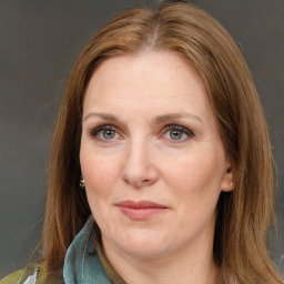 Joyful white adult female with long  brown hair and brown eyes