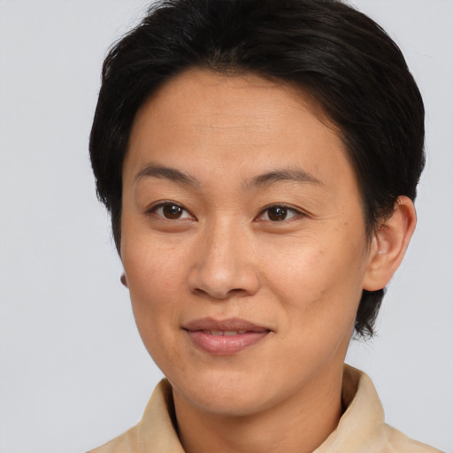 Joyful asian adult female with short  brown hair and brown eyes